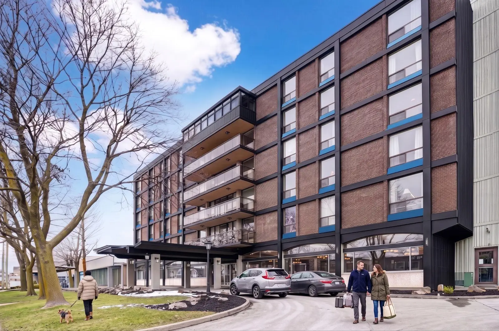 The exterior of The Horton — mid-century brick with new black frames and blue accents
